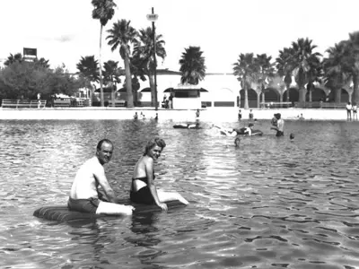 people in the water, near the shore