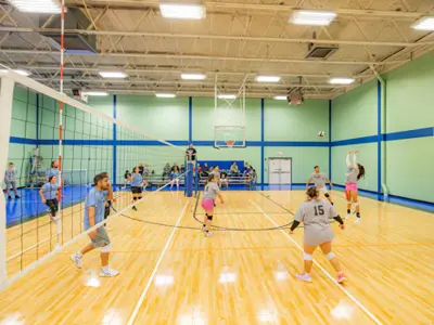 People playing volleyball in gym