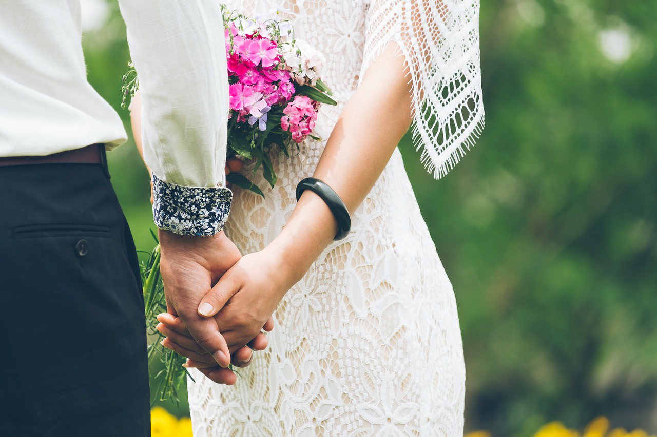 Married couple holding hands