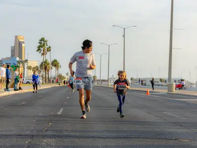 Man and child running in marathon