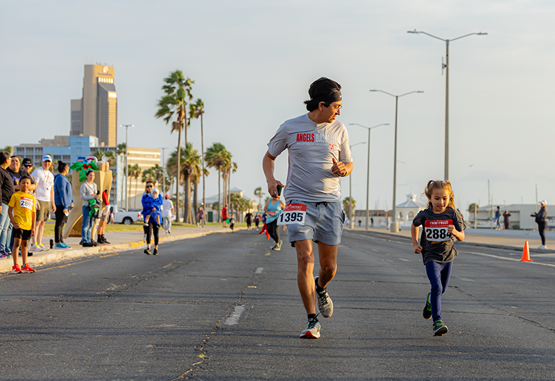 Man and little girl running marathon