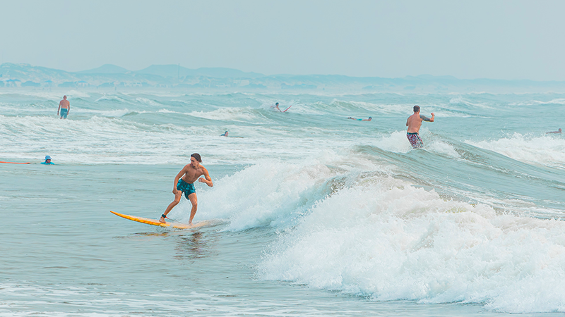 Surfing at North Packery Beach